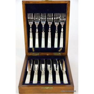 A set of silver-plated fish knives and forks with hardwood…
