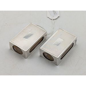 A pair of sterling silver Matchbox holders, engine turned…