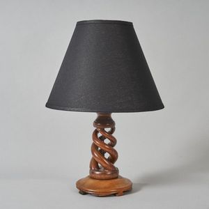 An Arts & Crafts corkscrew lamp, circular wooden base with…