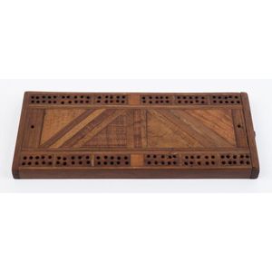An antique cribbage board made by Allan Duckworth with label…