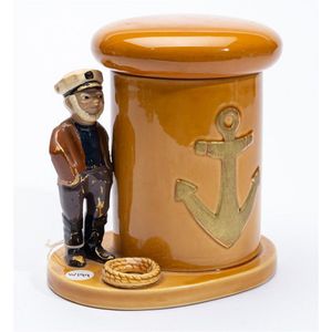 A ceramic tobacco jar and pipe stand with navy figure, height…