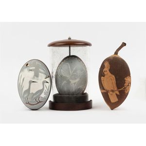 An etched and decorated emu egg under glass, together with an…