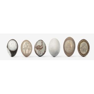 A collection of six etched and carved emu eggs, each variously…