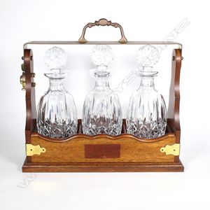 Three Waterford Lismore pattern decanters, set in a brass…