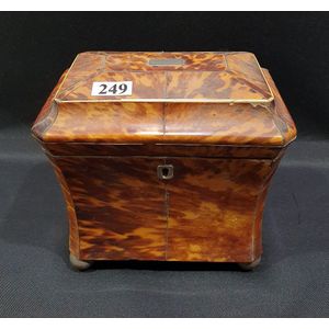 A tortoiseshell tea caddy, with ivory inlay, sarcophagus shaped,…