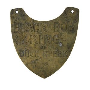 Aboriginal Breastplate. Hand chased shield form brass, 'Black…