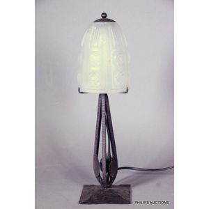 A signed Art Deco wrought iron and frosted glass table lamp,…