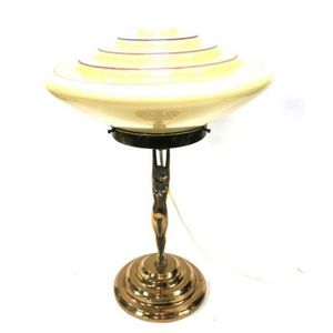 An Art Deco style female figure table lamp with cream glass…