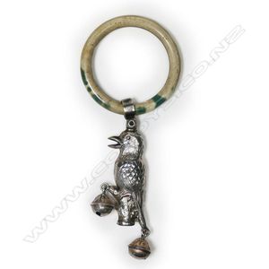 And ivorine baby rattle, a silver kookaburra with two small…