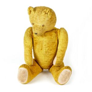 A large vintage plush teddy bear, straw filled with glass eyes…