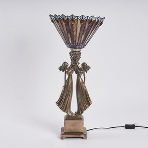 A modern Tiffany style lamp, with a figural base and stained…