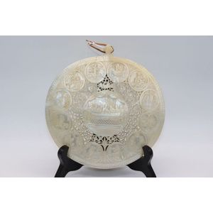 Carved mother of pearl shell, intricately carved with scenes…