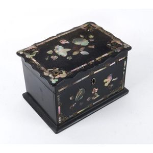 An antique tea caddy, papier mache inlaid with mother of pearl,…