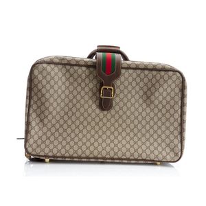 A suitcase by Gucci, styled in brown supreme coated canvas with…