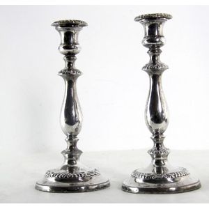 A pair of Sheffield plate candle sticks, each with an inverted…