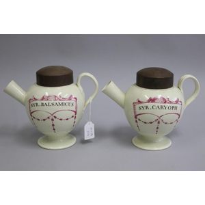Pair of cream ware lidded syrup jars with puce decoration with…