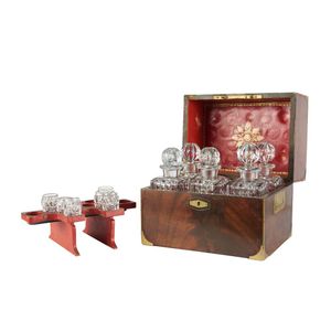 A mahogany tantalus set, 19th century, the brass bound mahogany…