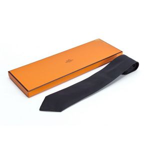 A tie by Hermes, styled in black silk, boxed. As new. Appears&hellip;