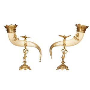 A pair of bovine horns on decorative gilded mounts, circa 1880.…