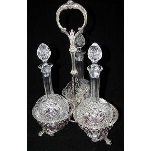 An Elkington plate three crystal bottle cruet set