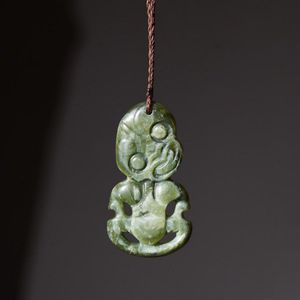 A Bowenite pounamu hei tiki, Orthodox form with hands clasped…