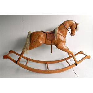 A French timber veneer rocking horse with leather saddle, 115 x…