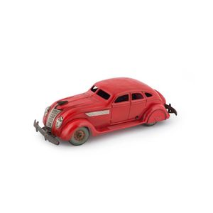 A 1930's Chrysler Airflow wind-up four-door sedan in bright red;…