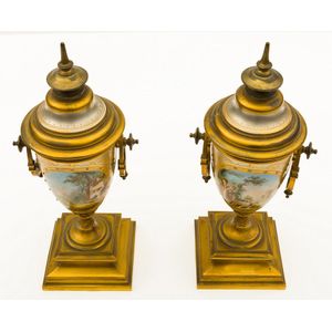 A pair of French gilded bronze urns, with hand painted scenes,…