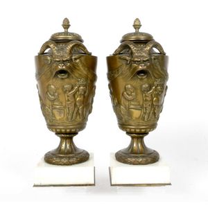 A pair of French 19th century bronze covered urns, with goat…
