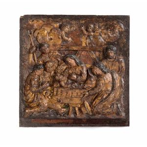 A carved and gilt polychrome wooden panel of the nativity scene,…