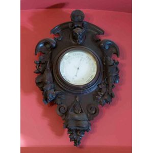 A pair finely carved black forest frames one with a clock and…