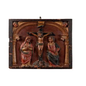 A Bohemian polychrome carved wooden panel of the crucifixion,…