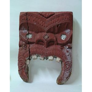 A 19th century Maori carved stylised mask, notch, linial and…