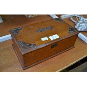 An antique English Arts & Crafts oak cigar box with copper…