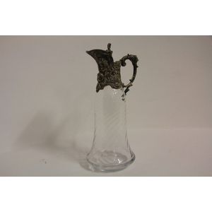 A continental plated and glass claret jug having mask head and…