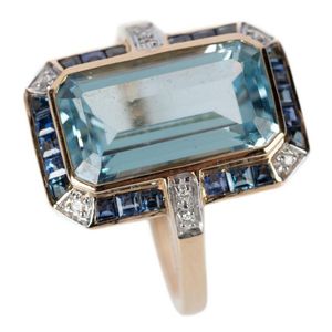 A retro style topaz sapphire and diamond ring, featuring an…