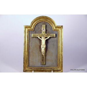An Ivorine crucifix in a gilded frame, circa 1900, the ivorine…