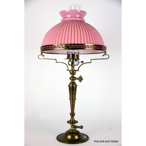 An antique bronze gas lamp with a pink glass shade, late 19th…