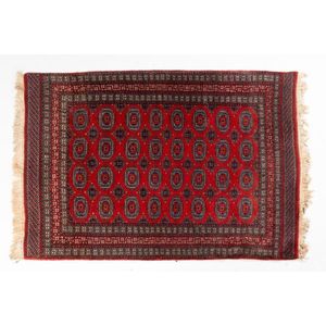 An Afghan rug, with repeating lozenge pattern on a red field&hellip;