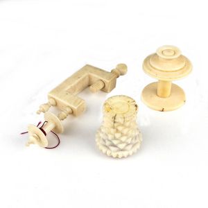 Three vintage ivory and bone sewing items, includes a carved…