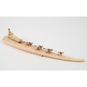 An Inuit carved walrus tusk ornament with dog sled team, early ...