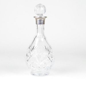 A crystal and silver spirit decanter, cut decoration to body…
