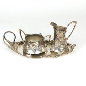 A WMF silver plated milk jug and sugar basin on stand,…