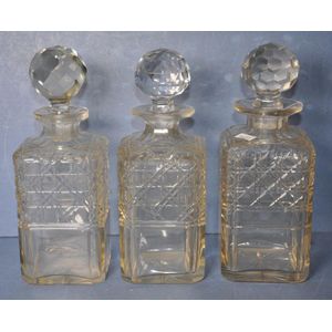 Three matching cut crystal tantalus decanters height 23 cm,