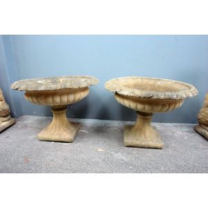 A pair of church stone classical garden urns, low flat flared…