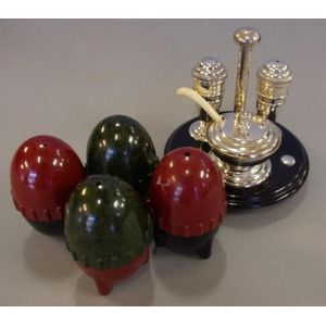 Cruet set on bakelite stand together with two pairs of Bakelite…