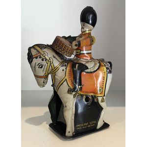 A collection of tin toys, including a mounted Drumming soldier…