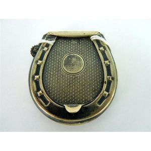 A silver-plate horseshoe match case, with integral lighter;…