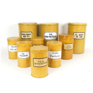 Nine European pharmacy tins, painted to simulate wood grain and…