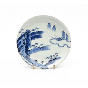 A Japanese blue and white dish depicting trees in a landscape.…